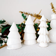 Load image into Gallery viewer, White ceramic Christmas trees with gold accents on a decorative background