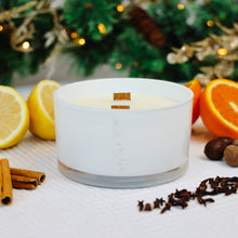 Load image into Gallery viewer, MJM Branded candle in white glass jar with double wooden wick. Surround by ingredients depicting the citrus and spiced notes of the candle.