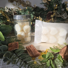 Load image into Gallery viewer, Jar & bar of wax melts with a festive decorative background featuring greenery and lights.