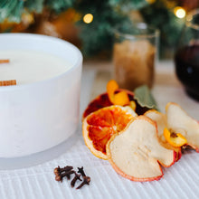 Load image into Gallery viewer, Candle with dried fruits and spices on a textured surface, with a festive background