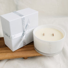 Load image into Gallery viewer, Picture of a 50cl candle with double wooden wicks, in a white glass vessel. The candle is accompanied by a white gift box, finished with MJM Home Fragrance branded ribbon