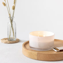 Load image into Gallery viewer, Picture of a lit large candle, with double wooden wicks in a white glass vessel with MJM Home Fragrance branding 
