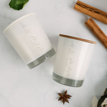 Load image into Gallery viewer, Two small MJM Home Fragrance branded candles, one with a white lid, the other with a wooden lid surrounded by star anise &amp; cinnamon sticks
