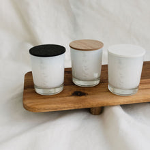 Load image into Gallery viewer, An image of 3 small MJM Home Fragrance candles, each with a different coloured lid (white, wooden &amp; black) to assist customers to make a choice as to their preffered lid colour
