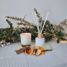 Load image into Gallery viewer, Decorative diffuser with candles and natural elements on a textured surface
